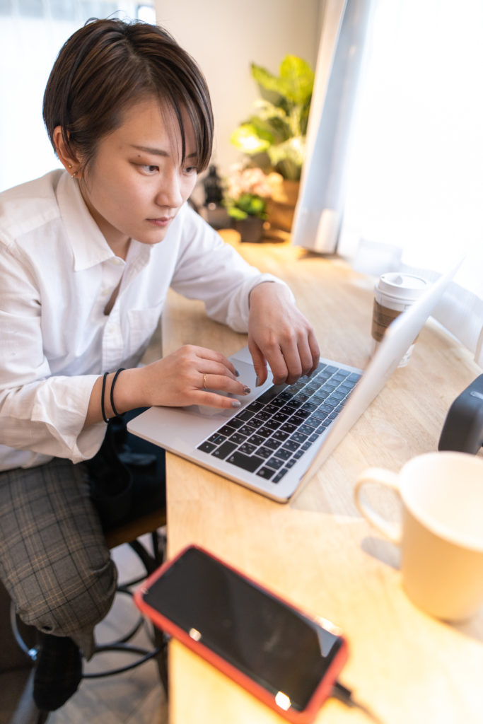Young woman working at home alone
