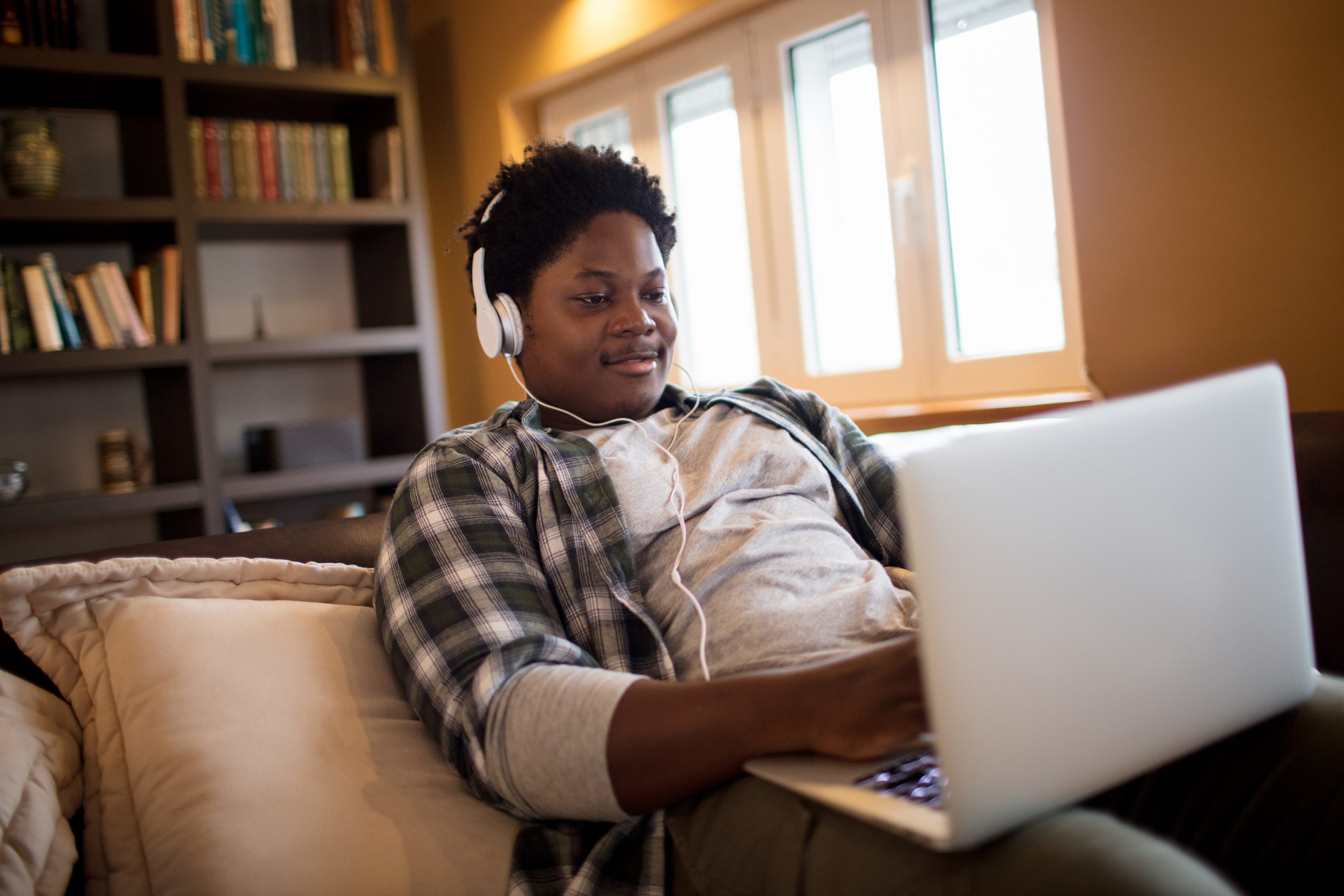 Close up of a young man using a laptop