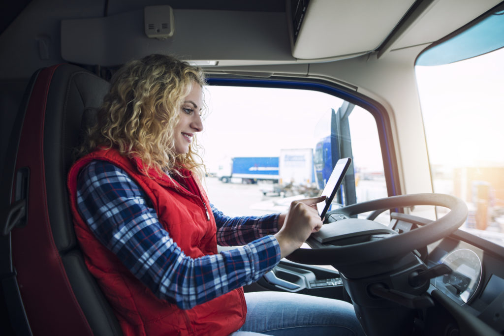 Female trucker using tablet computer for navigation
