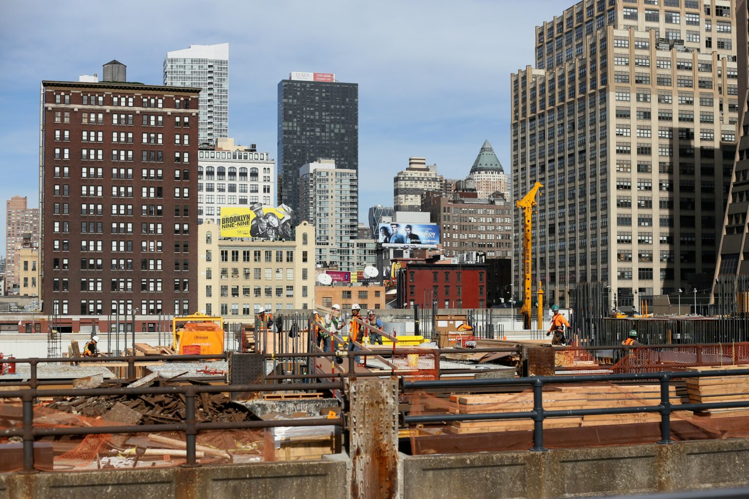 a view of a city construction site with tall buildings in the background
                                           